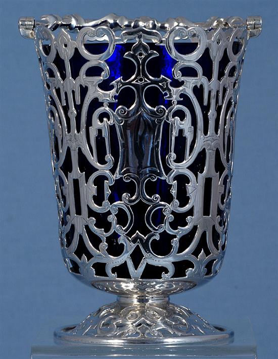 An early Victorian silver swing handled sugar basket and blue glass liner, Height: to handle 7 ¾”/195mm Top Dia 4”/100mm